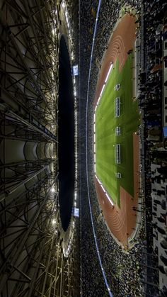 an aerial view of a baseball stadium with the lights on and fans in the stands