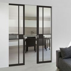 a living room filled with furniture and sliding glass doors