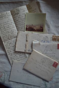 many old letters and envelopes are on the bed