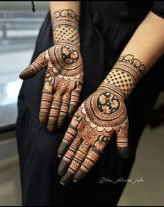 a woman's hands decorated with hennap and intricate designs on her hand