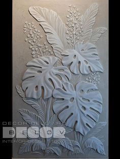 a decorative wall panel with leaves and flowers on it's side, in white