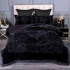 a bed with black comforters and pillows in a room