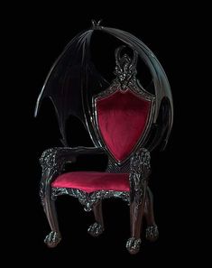 an ornate chair with a bat shaped back and arm rests in front of a black background