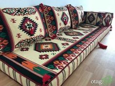 a couch that is covered in many different colors and patterns on it's sides