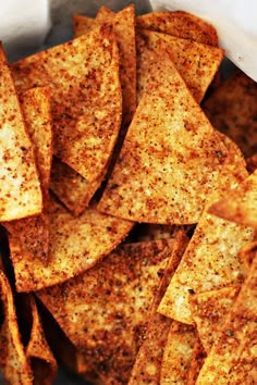 a bowl filled with tortilla chips on top of a table