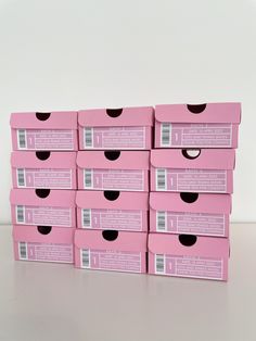 six pink boxes are stacked on top of each other with black holes in the middle