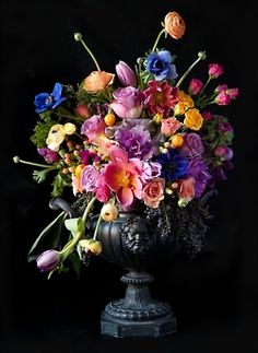 a vase filled with lots of colorful flowers