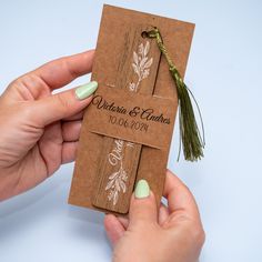 two hands holding brown paper tags with green string and leaves on them that say, rustic & chicques