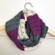 a crocheted scarf hanging on a clothes hanger