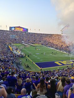 a football stadium filled with people watching the game