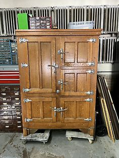 an old wooden armoire sitting in front of a radiator