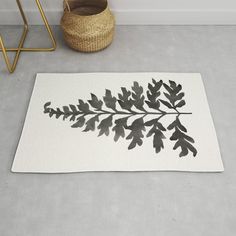 a black and white rug with leaves on it