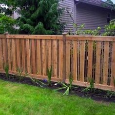 a wooden fence in front of a house