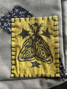 a close up of a piece of cloth with a butterfly on it