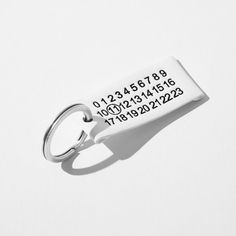 a keychain with the number and date printed on it's front side