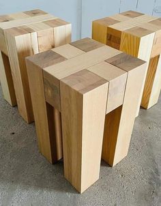 three wooden stools sitting next to each other in a room with concrete flooring