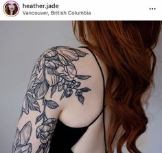 the back of a woman's arm with flowers on it, and leaves all over her body