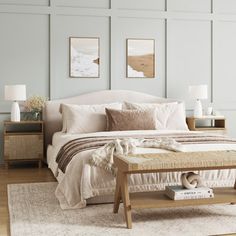 a white bed sitting on top of a wooden floor