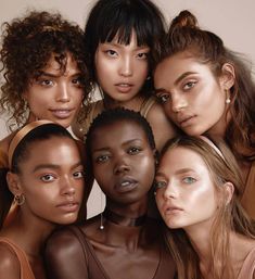 five models pose together in front of a white background