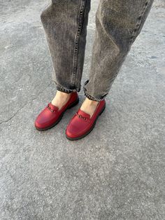 "These gorgeous women's red leather loafers with a metallic buckle on the strap are the perfect combination of style and sophistication. The premium natural leather material and stable 3 cm heel provide both durability and comfort, while the metallic buckle adds a touch of elegance to the design. The vibrant red color of these loafers makes them a standout addition to any outfit, while the metallic buckle on the strap adds a subtle yet eye-catching detail to the overall design. These loafers are Casual Burgundy Leather Loafers, Burgundy Leather Casual Loafers, Red Flats With Rubber Sole For Fall, Leather Loafers With Red Sole, Red Elegant Moccasins, Leather Platform Loafers With Leather Sole, Red Business Loafers, Red Business Loafers For Fall, Red Low Heel Flats For Office