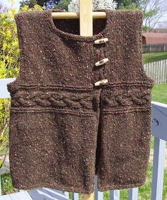 a brown knitted vest hanging on a clothes line