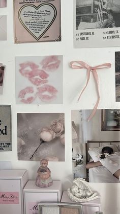 a wall covered in pictures and other items with pink ribbons on it's edges