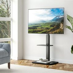 a flat screen tv sitting on top of a wooden stand