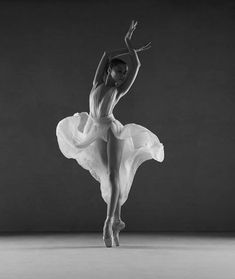 a black and white photo of a ballerina