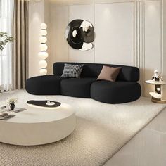 a black and white living room with round coffee table in the middle, large mirror on the wall