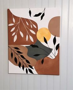 a painting hanging on the side of a wall with leaves and branches painted on it