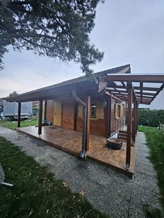 a small wooden house sitting on top of a lush green field