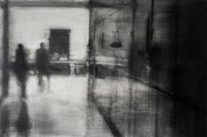 a black and white photo of people walking down a hallway in a building with no doors