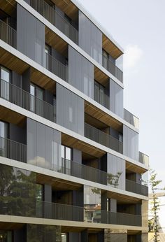 an apartment building with balconies on the second floor