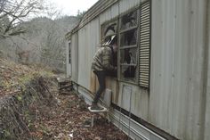 a man standing on the side of a train car