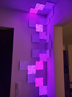 a room with purple squares on the wall