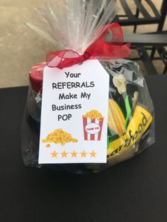 a plastic bag filled with popcorn and some sort of business card on top of it