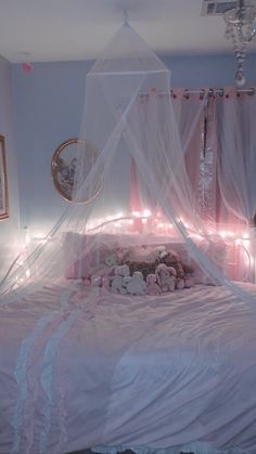 there is a bed with pink sheets and teddy bears on it