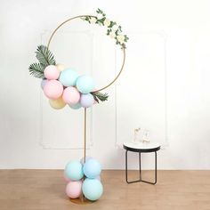 a table with some balloons on it and a plant in the corner next to it