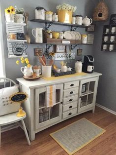 an image of a room that is decorated in yellow and gray colors with coffee cups on the shelves