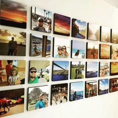 a wall with many pictures hanging on it