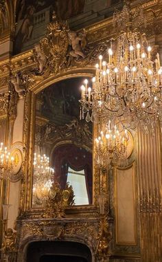 an ornate fireplace and chandelier in a room