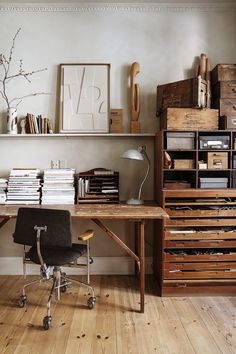 an office with lots of drawers and a desk that has a chair on it in front of the desk