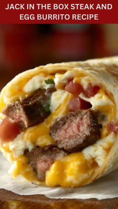 an egg burrito with meat and cheese on it