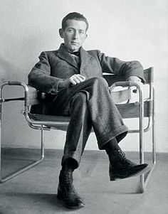 a man sitting in a chair with his legs crossed