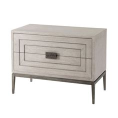 a white wooden cabinet with two drawers and one drawer on the bottom, in front of a