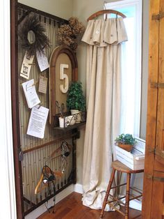 an entry way with a clock, chair and other items on the wall next to it