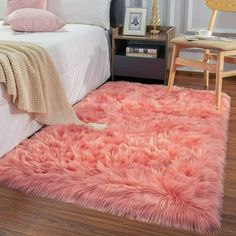 a bedroom with a pink rug on the floor