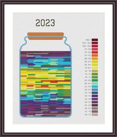 a cross stitch pattern with a jar filled with colored paint and the number twenty on it