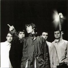 a group of young men standing next to each other in front of a street light