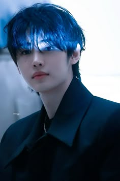 a man with blue hair and black shirt